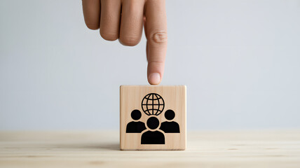 Global team collaboration concept, wooden cube with people and globe icon, building strong diverse teams