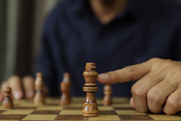 Hand chooses king chess for leadership business strategy plan or wining challenge and team player and risk management or human resource or strategic planning.