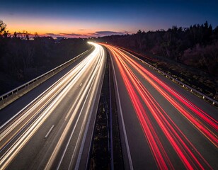 Highway at twilight, illuminated by streaks of car lights, creating a mesmerizing display of light trails.