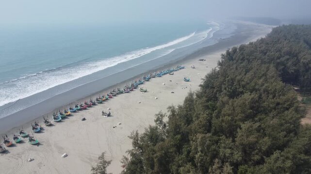 Aerial View of fishing boats and marine drive of Cox's bazar Sea Beach in Bangladesh. Traditional colorful fishing boats along the shoreline on the beach on Teknaf, Cox's Bazar, Chittagong, Bangladesh