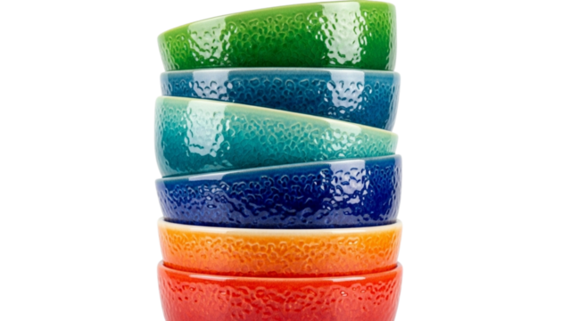 Vibrant stack of ceramic bowls against black background