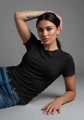 Portrait of a beautiful young woman in a blank black t-shirt and jeans posing in a studio