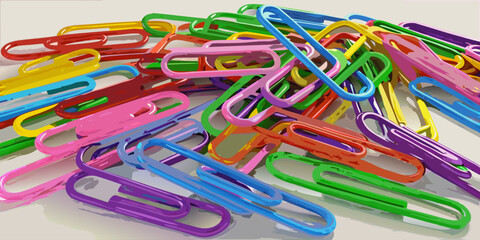 Colorful paperclips scattered randomly on a white background, showcasing a variety of bright hues and overlapping arrangements.