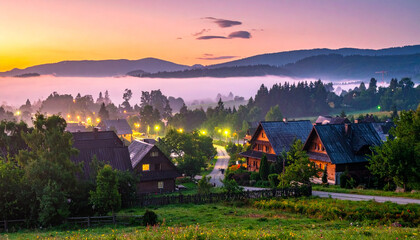 Fototapeta premium Fairy-tale mountain village in foggy sunrise light