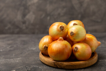 Onion on the kitchen table. onion slice. onion rings. Fresh Yellow Onion. Natural, fresh, vegetarian food. Agricultural products. Healthy eating. Vegetables. Farmer's market. Space for text.Copy space