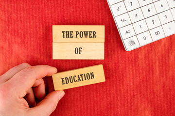 Business and Words Matter concept. Copy space. THE POWER OF EDUCATION assembled from blocks in a...