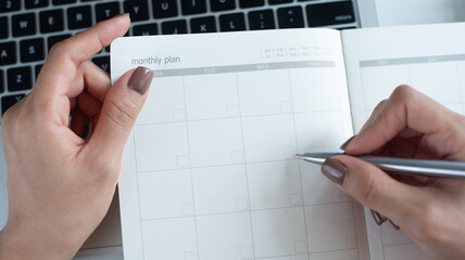 2026 Event planner timetable agenda plan on schedule event. Business woman checking planner, note...