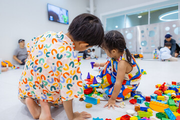 Kindergarten kids little boy and girl enjoy play toy block building