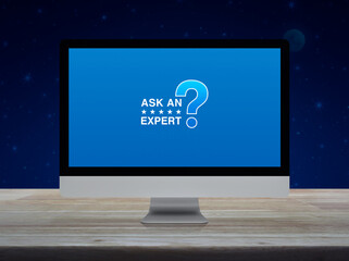 Ask an expert with star and question mark sign icon on computer monitor screen on wooden table over fantasy night sky and moon, Technology communication online concept