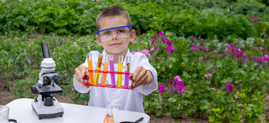 Boy conducting science experiments. Child with microscope