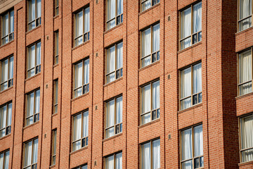 View of brick building facade with windows.