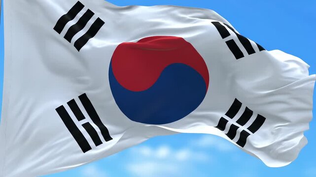 The national flag of South Korea, also known as the Taegeukgi, waving in the wind against a blue sky. - Powered by Adobe