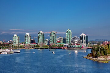Naklejka premium View at Vancouver Harbor Downtown of Vancouver City Science World museum sunny autumn day at the background of blue sky