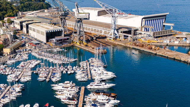 Aerial view of the Fincantieri Shipyard in Castellammare di Stabia, an important industrial hub for shipbuilding, with the port, docks, and the Gulf of Naples in the background. Italy.