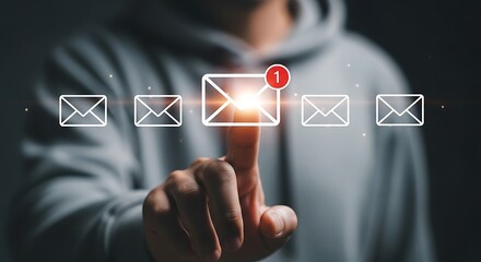 Person's Finger Touching Glowing Email Icon with Notification Alert message inbox