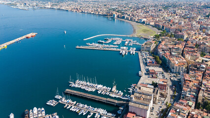 Aerial view of Castellammare di Stabia with its port, waterfront, and the Gulf of Naples, framed by...