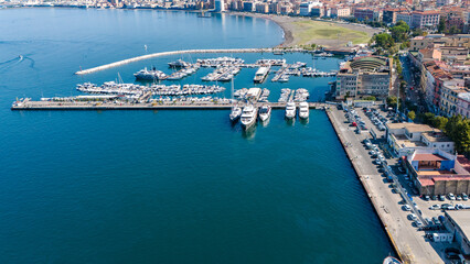 Aerial view of Castellammare di Stabia with its port, waterfront, and the Gulf of Naples, framed by...