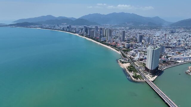 Aerial panoramic view of Southern part of Nha Trang city with coastal road, sand beach and mountains, Vietnam.