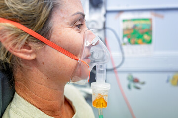 woman with oxygen nebuliser mask, closeup detail, gp general practice medical healthcare clinic, asthma COPD treatment