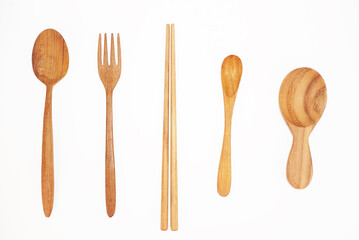 A variety of wooden eating utensils are placed side by side.
