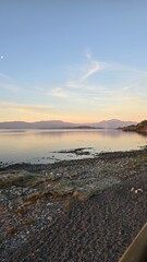 Golden sunset at Lago Ranco in southern Chile, with calm waters, mountains, and warm evening light creating a serene and picturesque landscape.