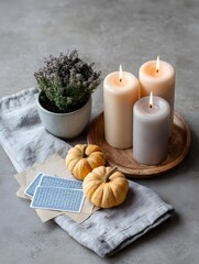 Vintage Halloween flat lay with candles tarot cards and mini pumpkins on parchment