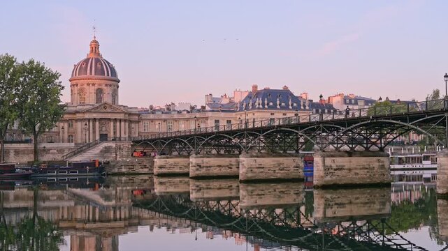 Twilight casts a soft glow on Pont des Arts as the Seine calmly flows beneath the bridge - Paris - France