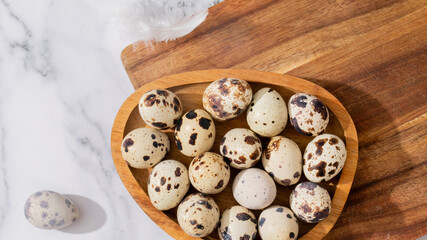 Speckled quail eggs nestled in rustic wooden bowl, evoking spring renewal, Ostara festival, culinary simplicity, nature's mosaic treasures