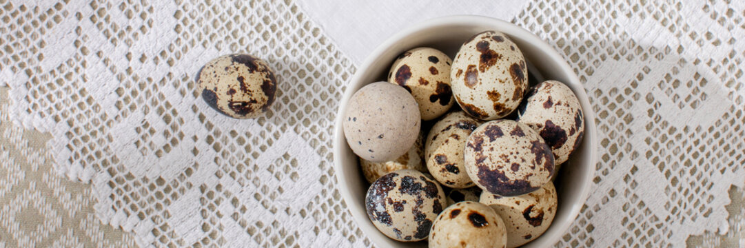 Quail eggs on delicate lace evoke springtime renewal, Ostara blessings, and gourmet delicacies beneath a rustic charm