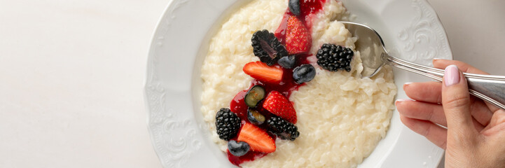 Creamy rice pudding adorned with vibrant berries evokes Midsummer sweetness, Nordic celebrations, and whimsical culinary artistry