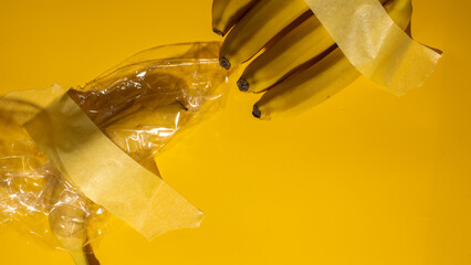 A surreal burst of taped bananas on vivid yellow canvas, echoing avant-garde expressionism, celebrates World Banana Day