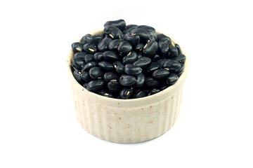 Black beans in a bowl on a white background.