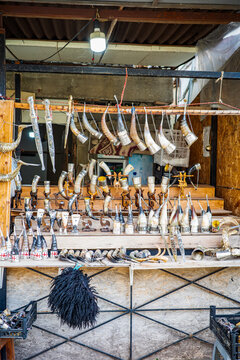 A vibrant display of traditional Georgian drinking horns, known as khantsi, at a local market stall. These handcrafted cultural items, decorated with intricate details, symbolize hospitality