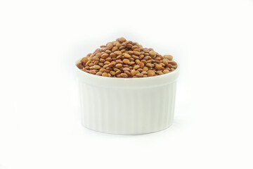 Vicia lens or Lens culinaris (Lens culinaris). Lentils brown, contains protein and soluble fiber, is a source of vitamin B.in a bowl on a white background.