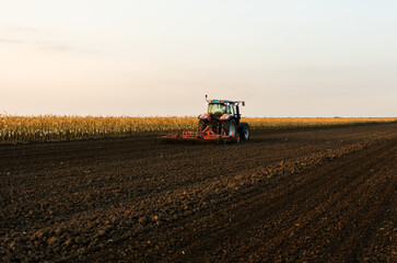Fototapeta premium Tractor preparing the land for a new crop planting