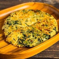 Golden, sliced savory pancake/omelette with spinach