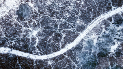 Flying above winding rivers and frozen swamps in winter.