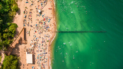 View from above beach with crowd at sea in summer.