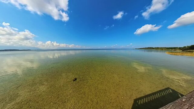 4K Timelapse video with moving clouds and waves at Lake Chiemsee, Chieming, Traunstein, Chiemgau, Bavaria, Germany