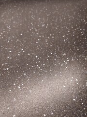 Detailed texture surface with specks background showcasing material quality