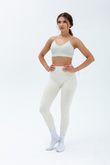 A Fitness Model striking a Stylish Pose while wearing trendy Activewear that stands out