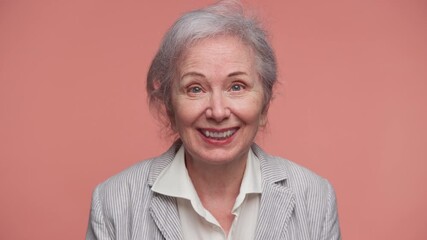 Elderly woman smiling during video call conversation - Powered by Adobe