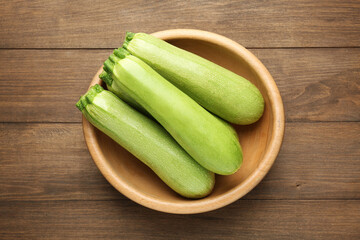 Fresh ripe zucchinis on wooden table, top view