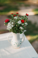 autumn flowers in a vase on the table in the evening sun