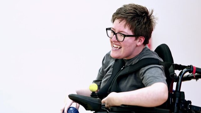 Woman in wheelchair playing boccia with focus