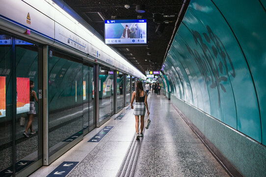 Woman walking at the subway platform, Hong Kong