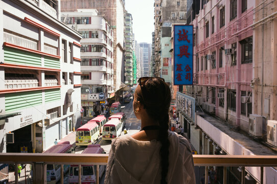Woman looking at road with traffic at daytime, Mong Kok, Hong Kong