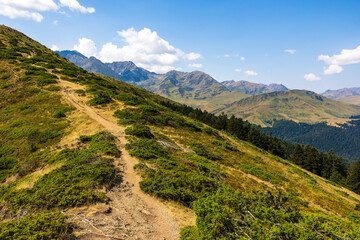 The Arbizon Massif seen from the Col d’Aspin, surrounded by verdant valleys and forested slopes...