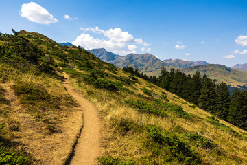 The Arbizon Massif seen from the Col d’Aspin, surrounded by verdant valleys and forested slopes...