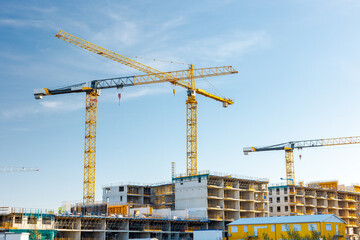 Apartment building construction site with cranes